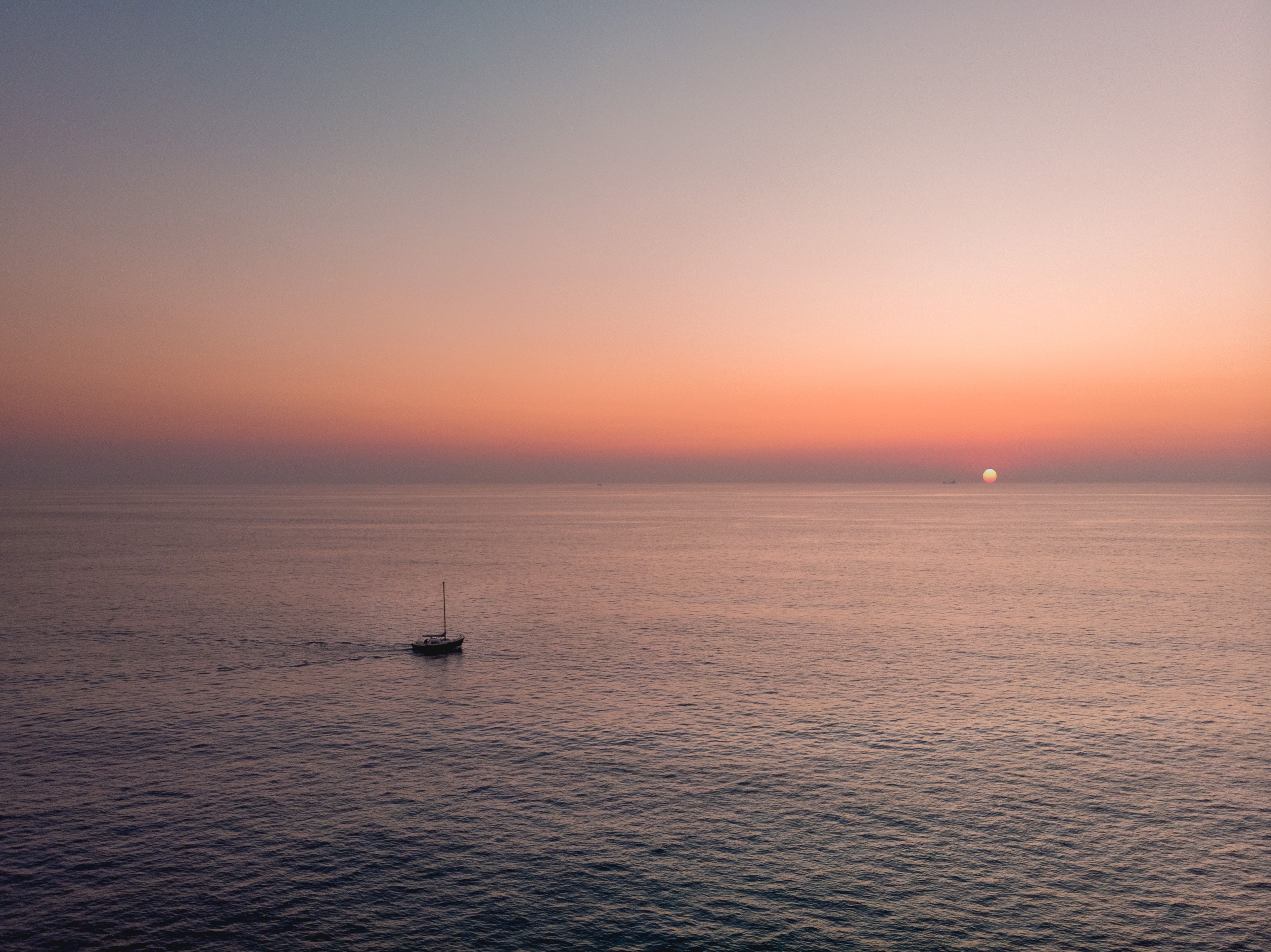 A yacht on calm water at sunset near Valletta, Malta.