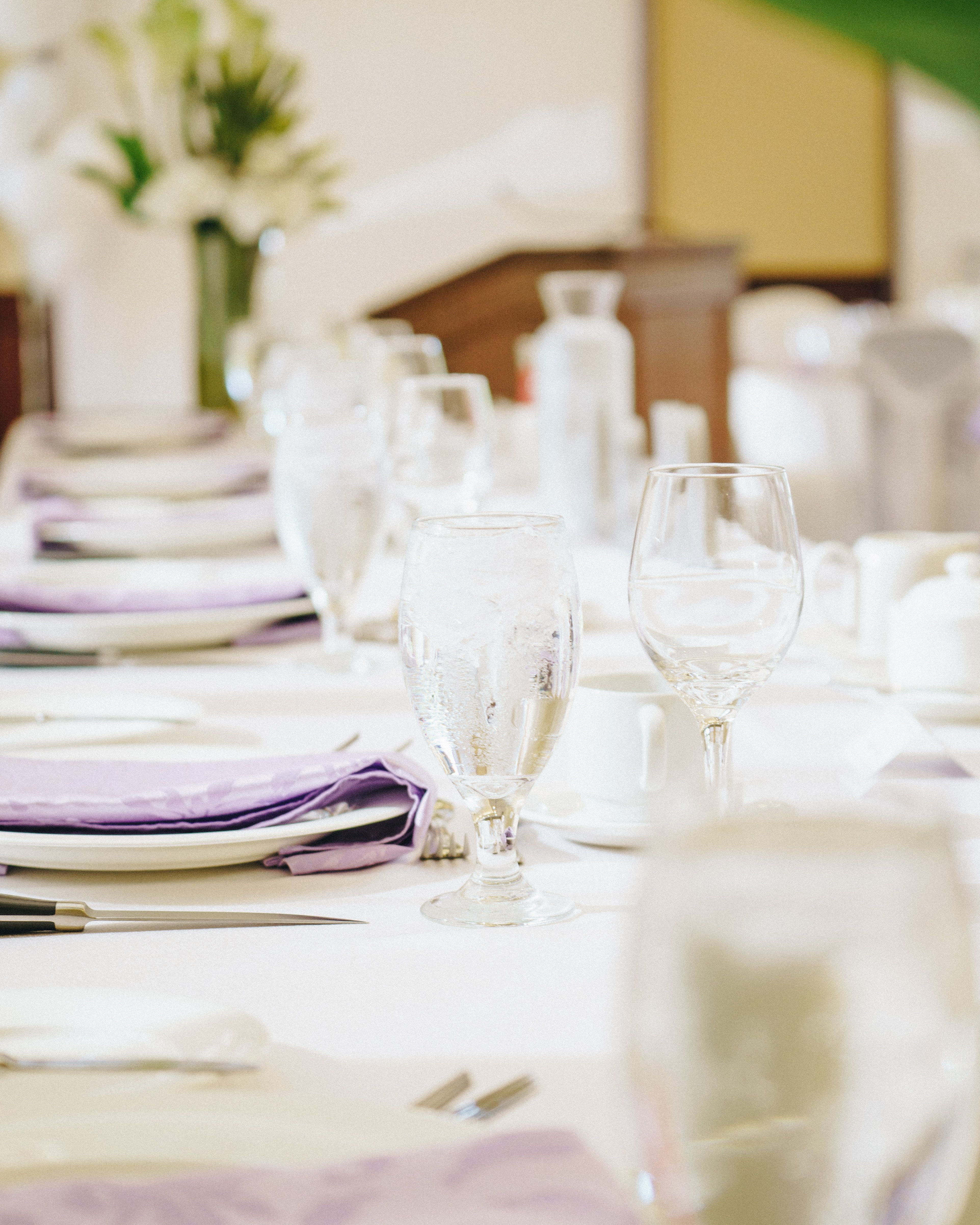 Glasses, cutlery and folded linen arranged for a formal meal.