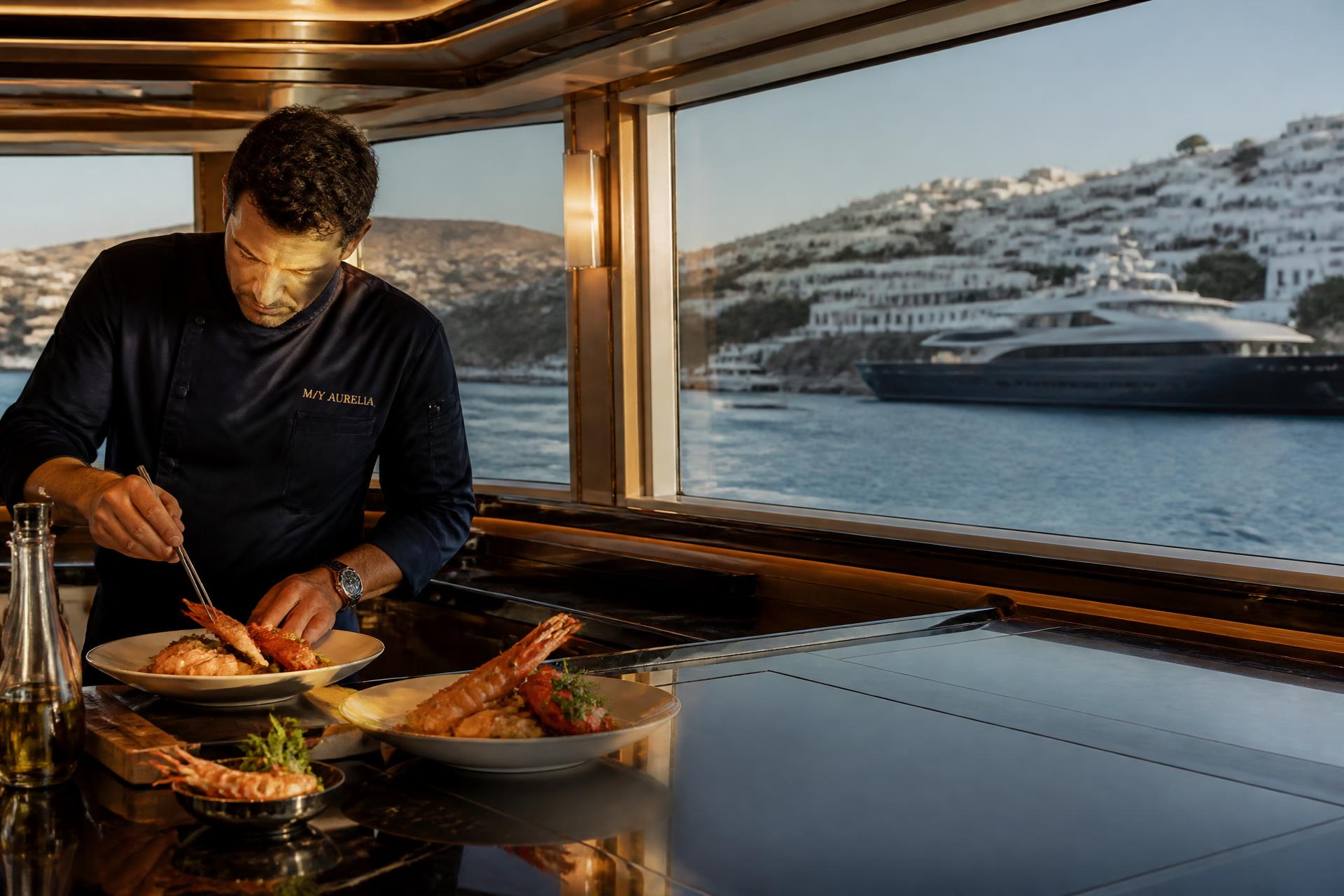 Private chef preparing fresh Mediterranean produce on a superyacht deck